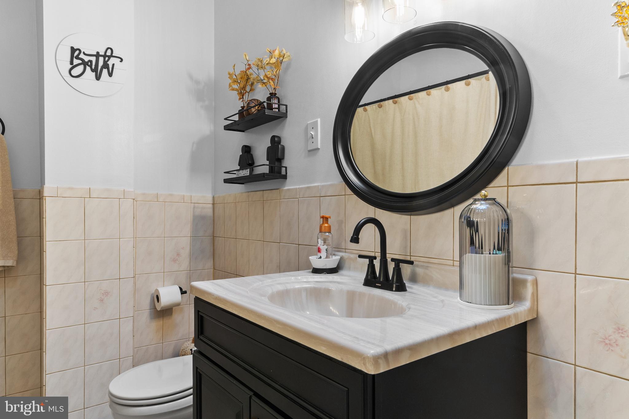 1642-44 Ridge Avenue Philadelphia, PA 19130 - Photo 17 of 24 a bathroom with a sink a toilet and a mirror