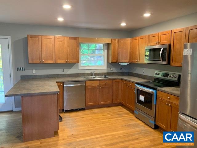 344 High Ridge Road Stanardsville, VA 22973 - Photo 6 of 9 a kitchen with stainless steel appliances granite countertop a stove a sink dishwasher and a microwave oven with wooden cabinets