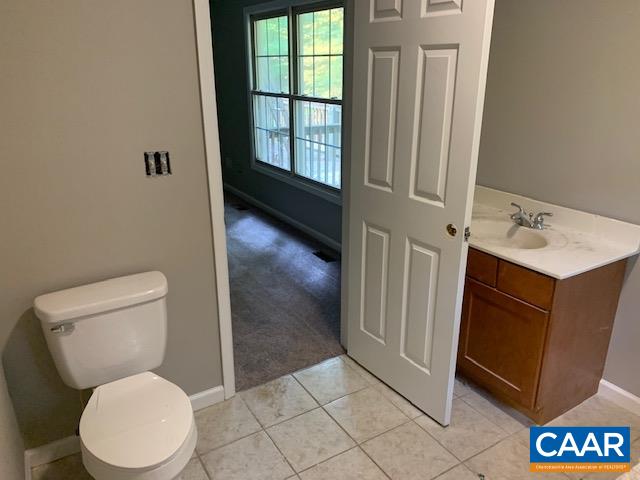 344 High Ridge Road Stanardsville, VA 22973 - Photo 8 of 9 a white toilet sitting next to a bathroom sink