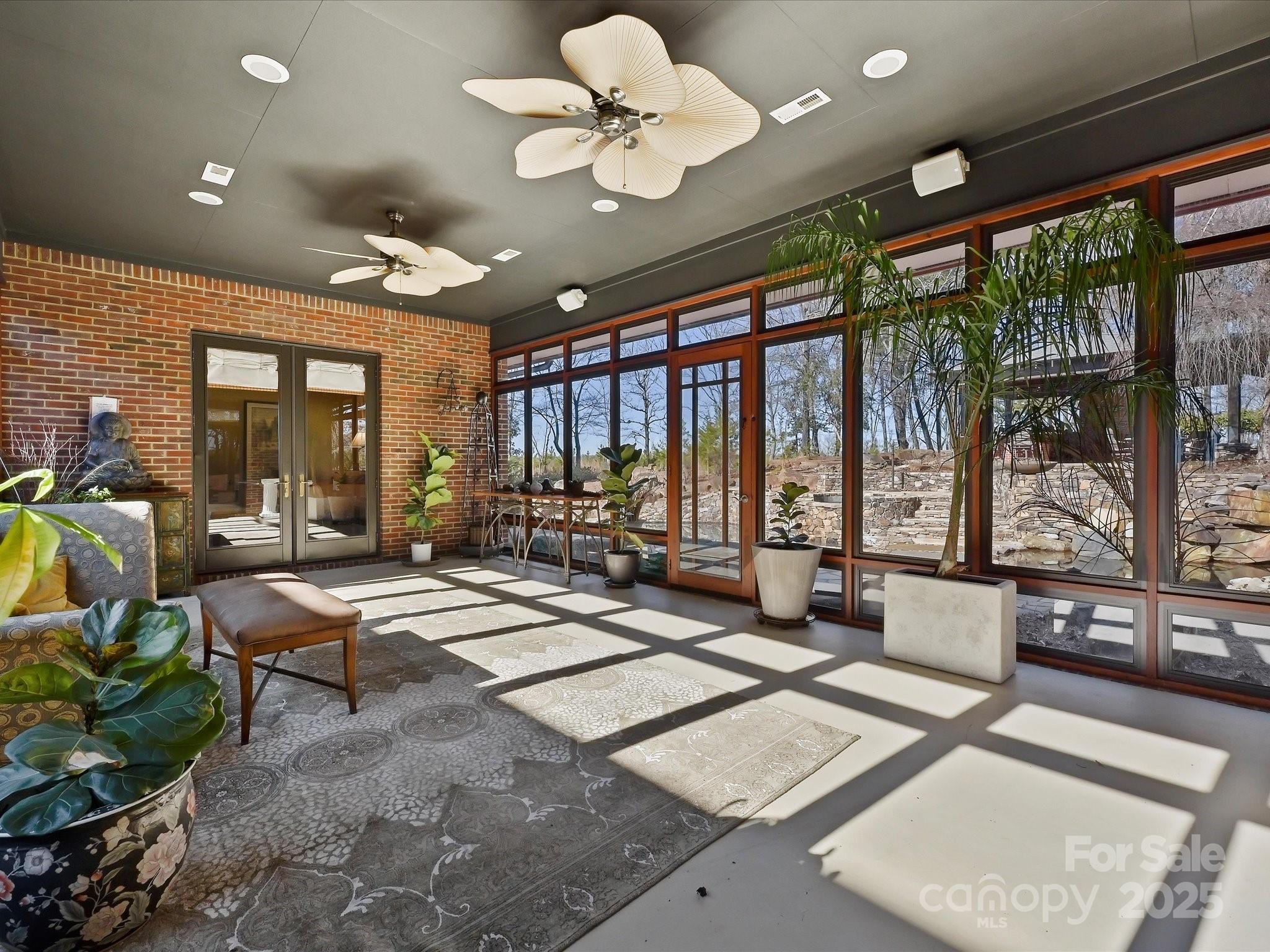 172 Tuckertown Road New London, NC 28127 - Photo 23 of 47 a living room with lots of furniture a chandelier and a large window