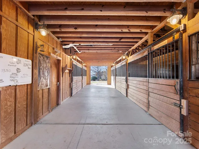 a large kitchen with granite countertop a refrigerator a sink and a large window