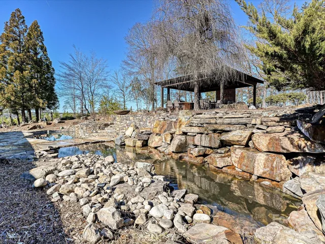 a living room with fireplace furniture and a large window