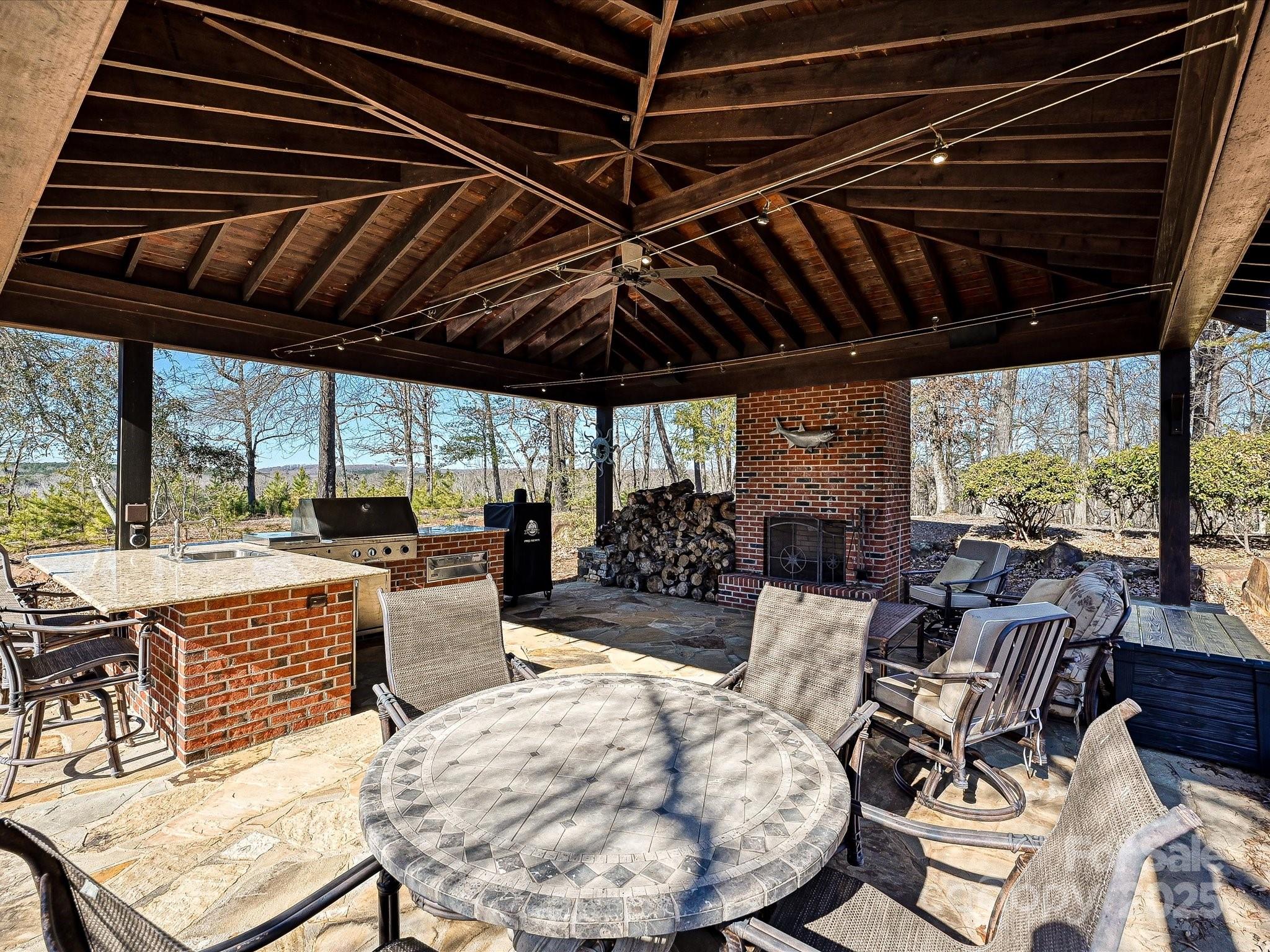172 Tuckertown Road New London, NC 28127 - Photo 9 of 47 a view of a patio with dining table and chairs with a barbeque grill
