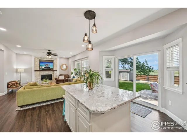 a kitchen with kitchen island a sink table and chairs