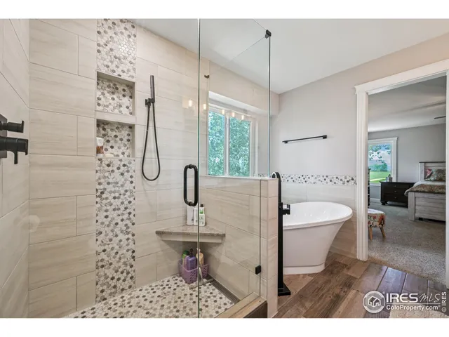 a bathroom with a sink a toilet a mirror and shower