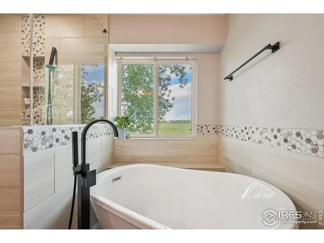 a bath tub sitting next to a window