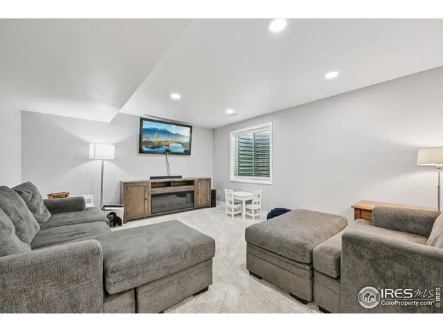 a living room with furniture a couch and a window