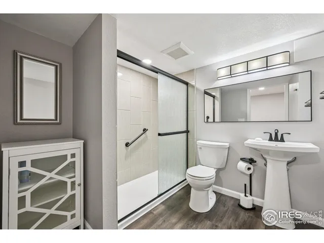 a bathroom with a sink toilet and a mirror