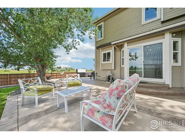 a view of a patio with couches table and chairs and potted plants