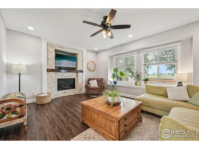 a living room with furniture a fireplace and a flat screen tv