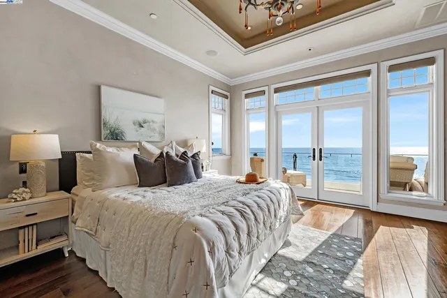 a bedroom with a large bed and a large window