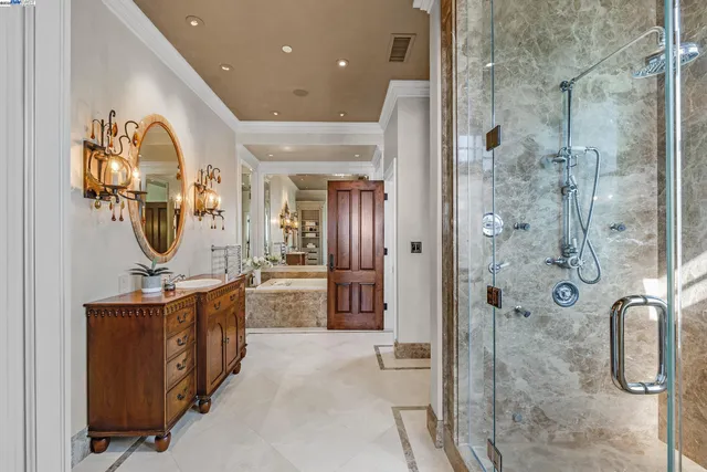 a bathroom with a granite countertop sink a mirror and shower