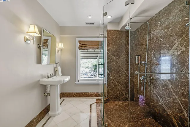 a bathroom with a granite countertop sink a mirror and a vanity