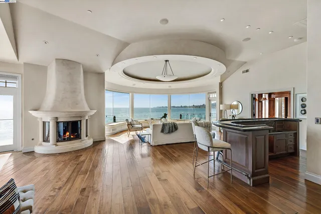 a living room with fireplace furniture and a wooden floor