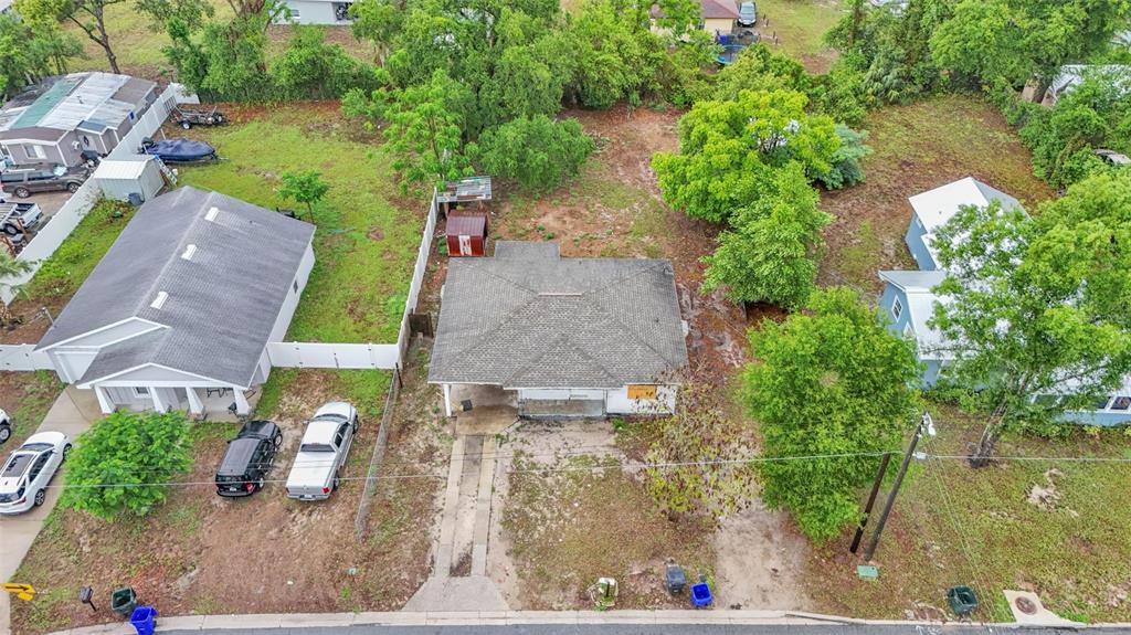 an aerial view of a house with garden space and a lake view
