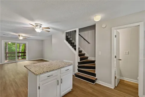 a kitchen with granite countertop a sink and a stove