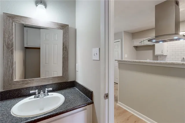 a view of a hallway with windows and chandelier