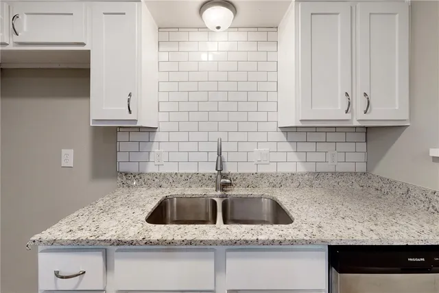 a kitchen with a sink and cabinets