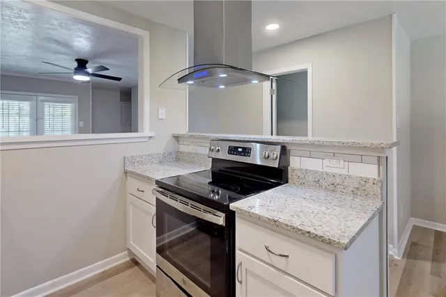 a stove top oven sitting inside of a kitchen