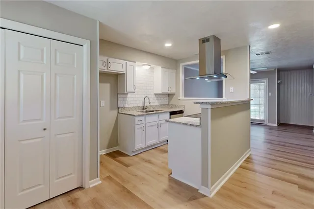 a kitchen with a stove and a white cabinet