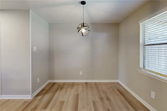 a room with white cabinets and sink