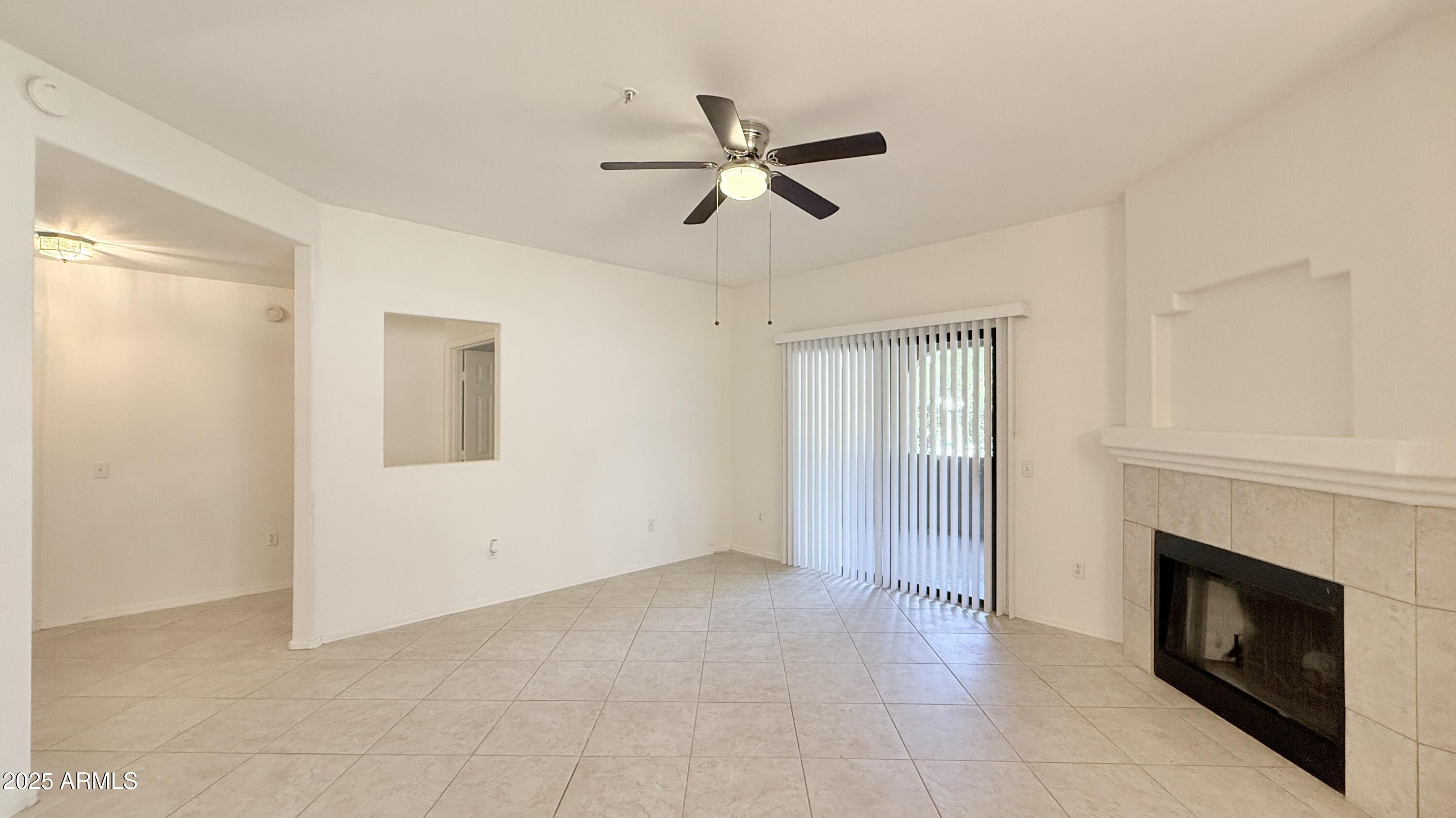 15050 North Thompson Peak Parkway, Unit 1012 Scottsdale, AZ 85260 - Photo 12 of 49 a view of empty room with fireplace and fan