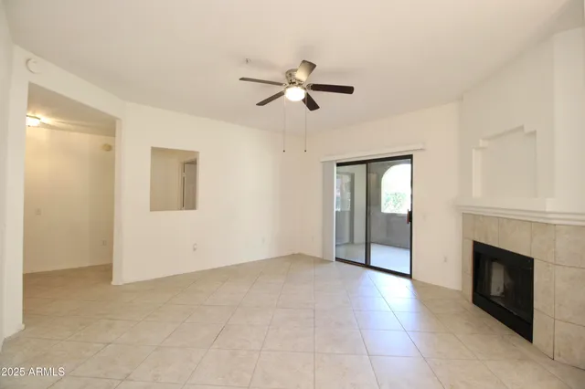 a view of empty room with ceiling fan