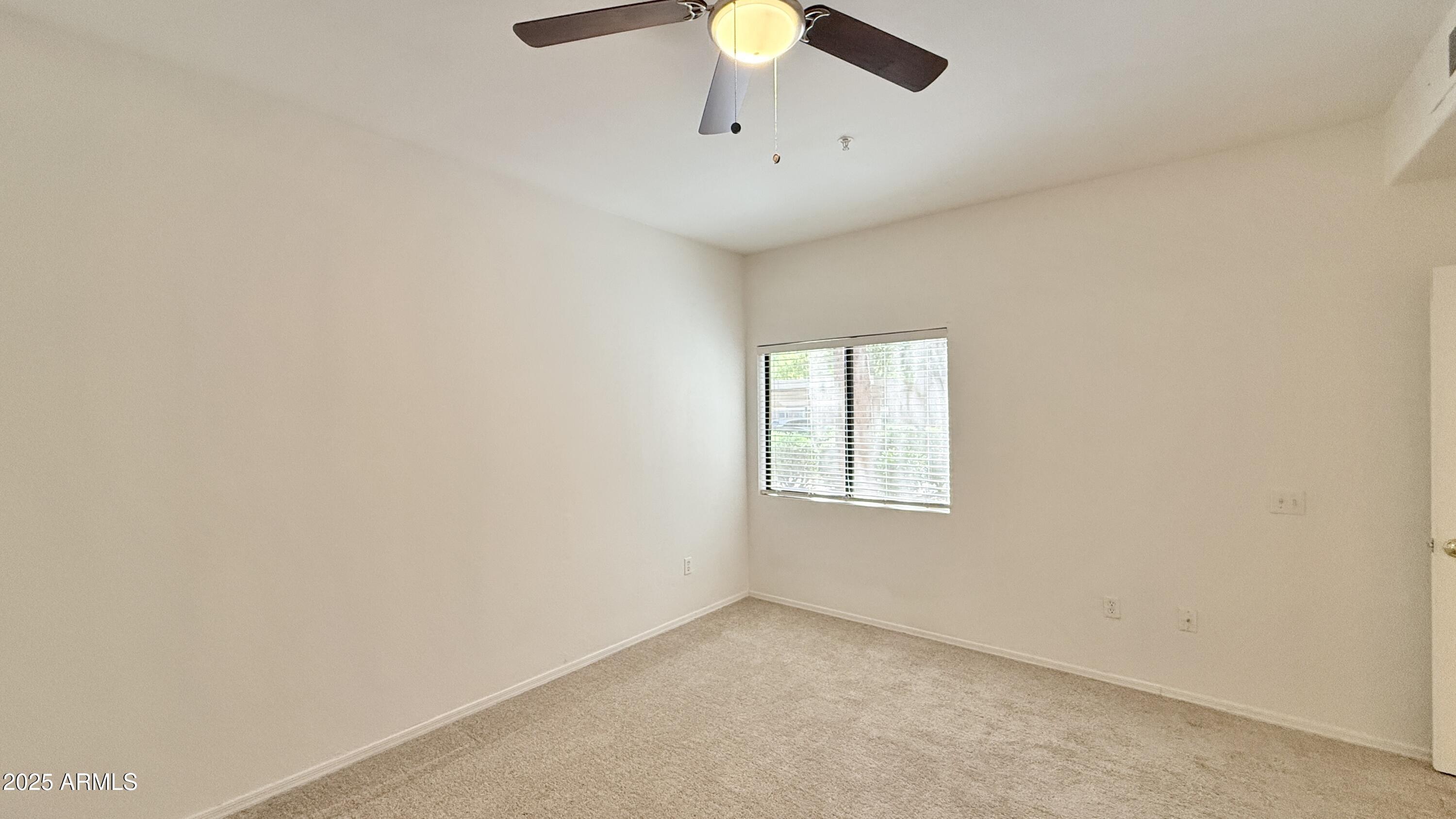 15050 North Thompson Peak Parkway, Unit 1012 Scottsdale, AZ 85260 - Photo 22 of 49 an empty room with a window