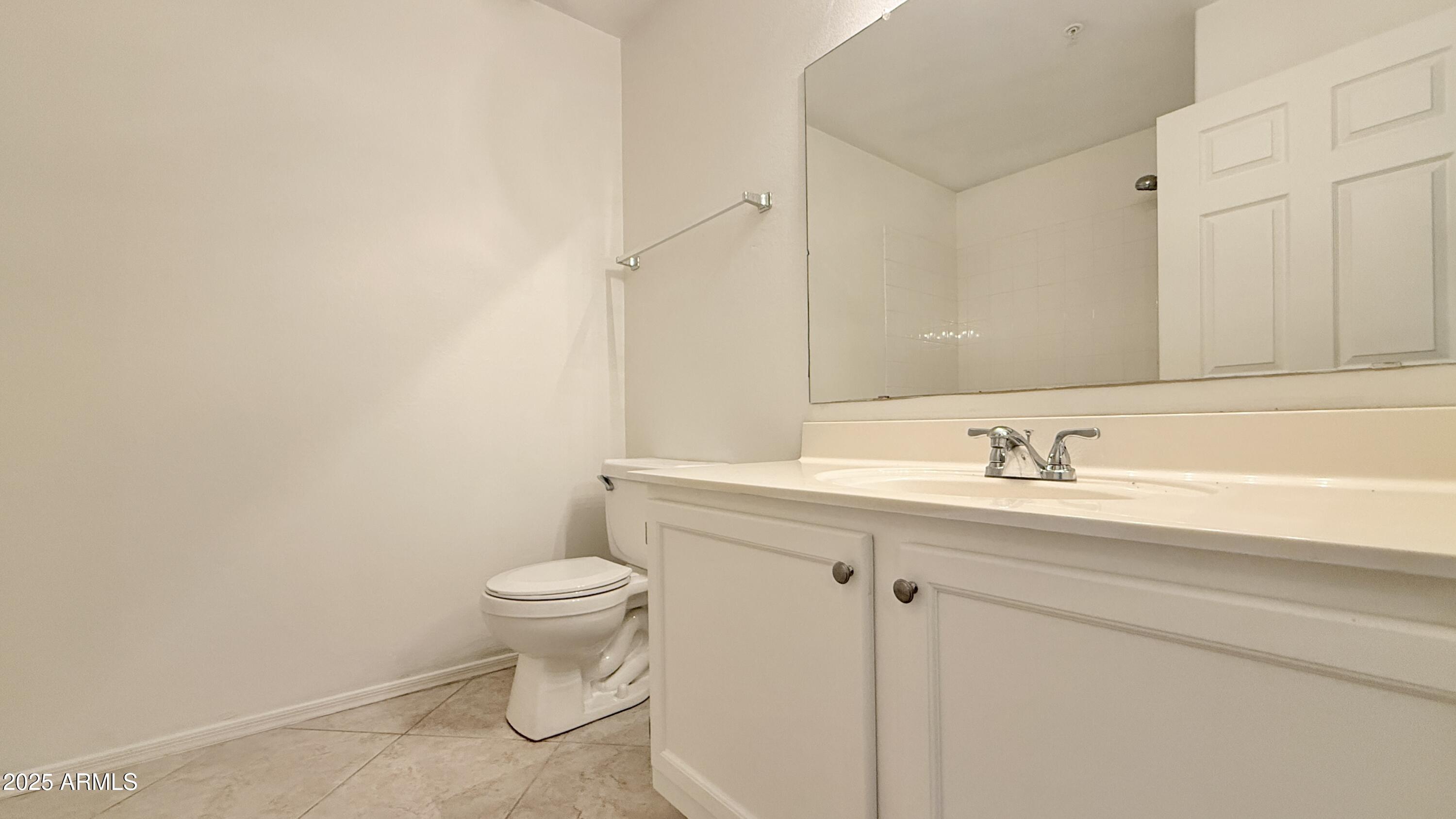 15050 North Thompson Peak Parkway, Unit 1012 Scottsdale, AZ 85260 - Photo 25 of 49 a bathroom with a sink a toilet and a mirror