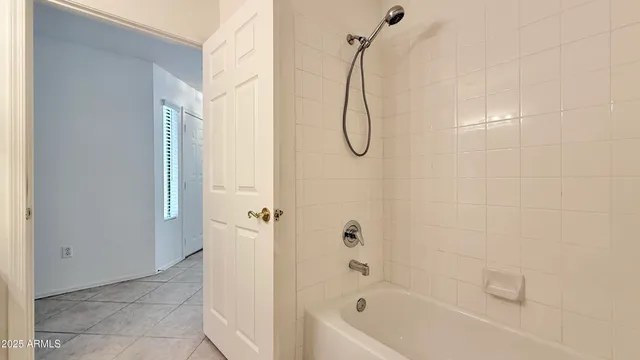 a bathroom with a bath tub with a shower