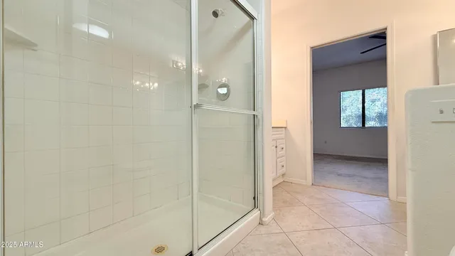 a view of a bathroom with a glass shower door and a sink