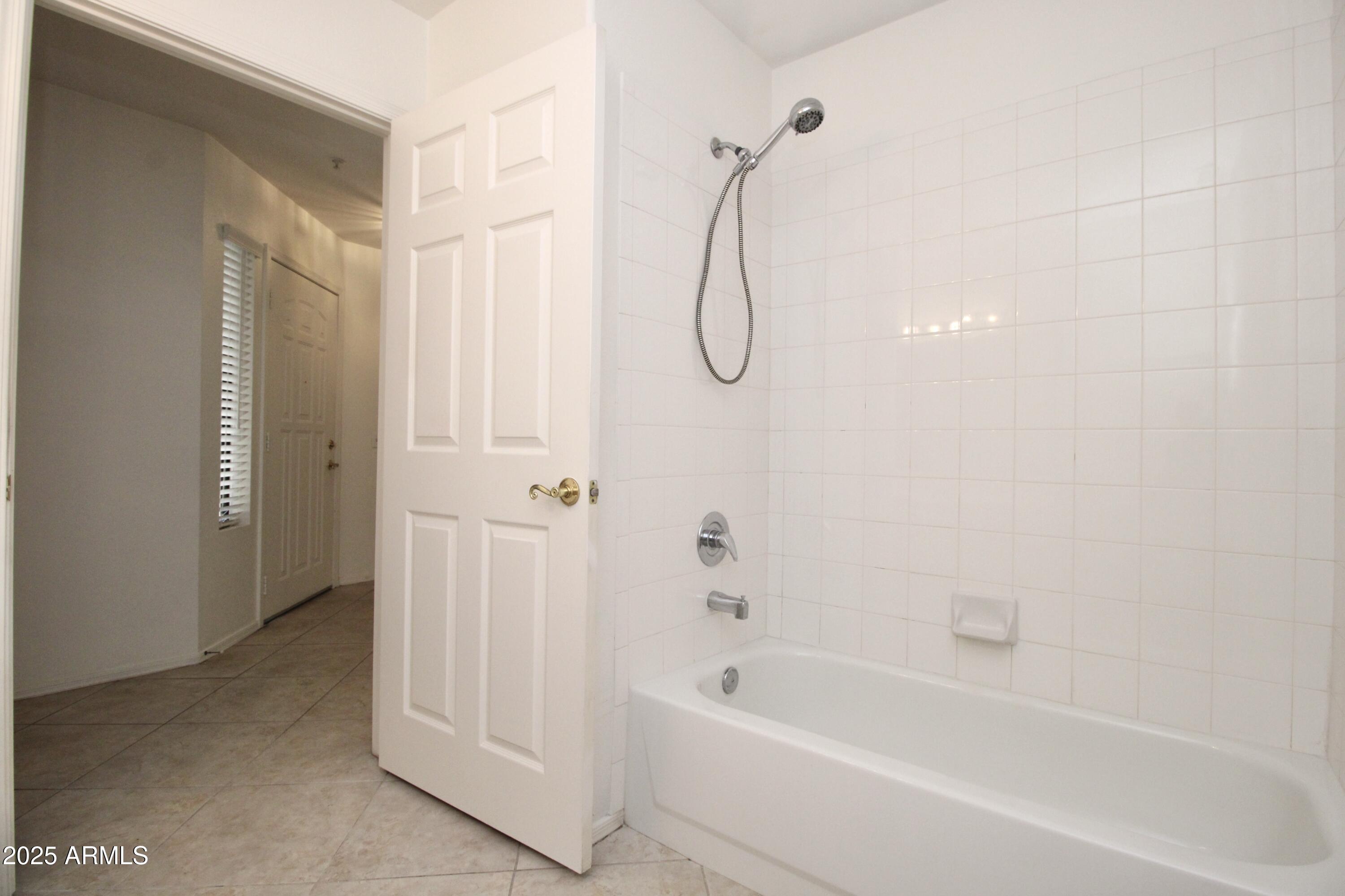 15050 North Thompson Peak Parkway, Unit 1012 Scottsdale, AZ 85260 - Photo 32 of 49 a bathroom with a bath tub with a shower