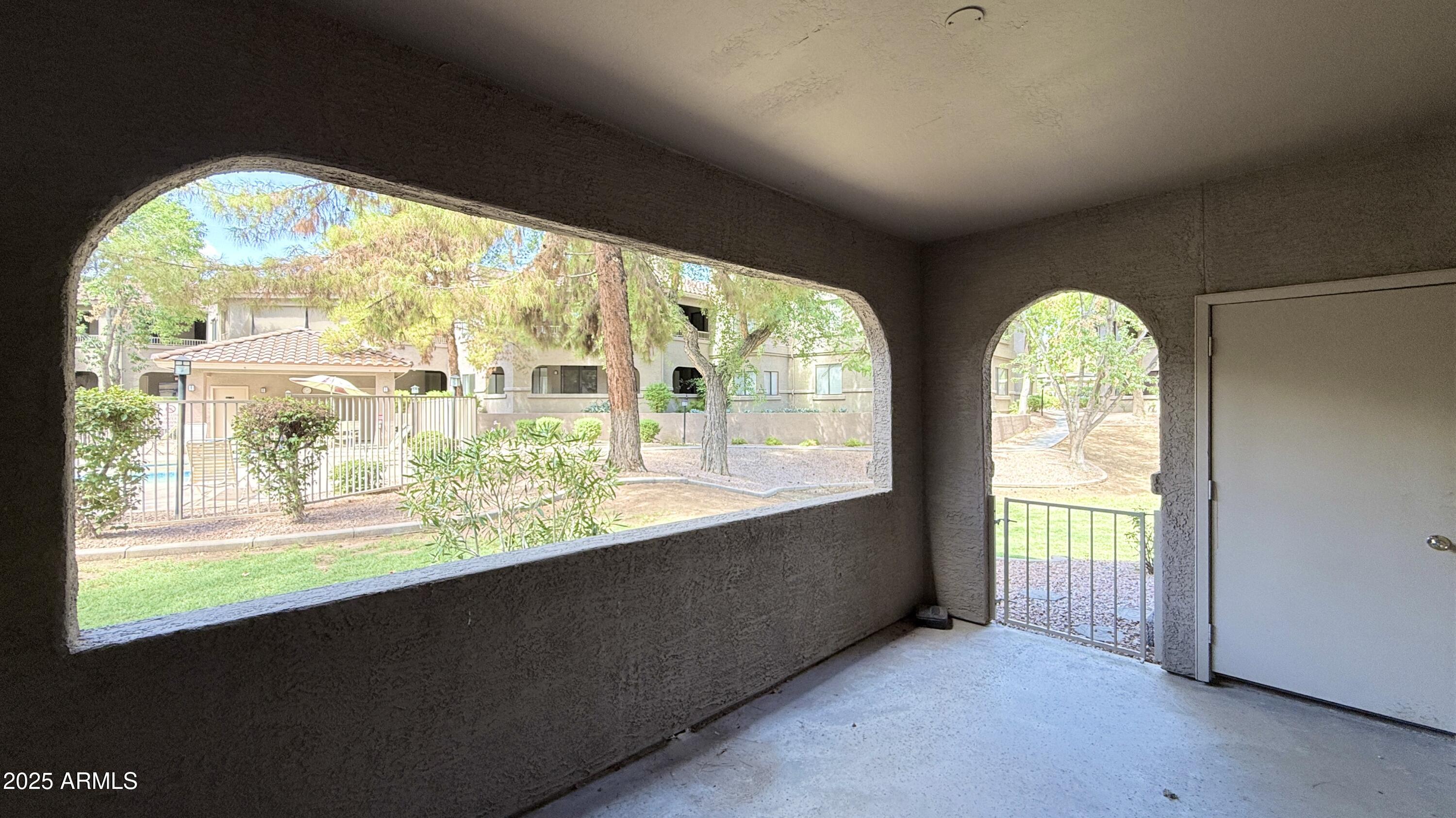 15050 North Thompson Peak Parkway, Unit 1012 Scottsdale, AZ 85260 - Photo 37 of 49 a view of an empty room with large windows