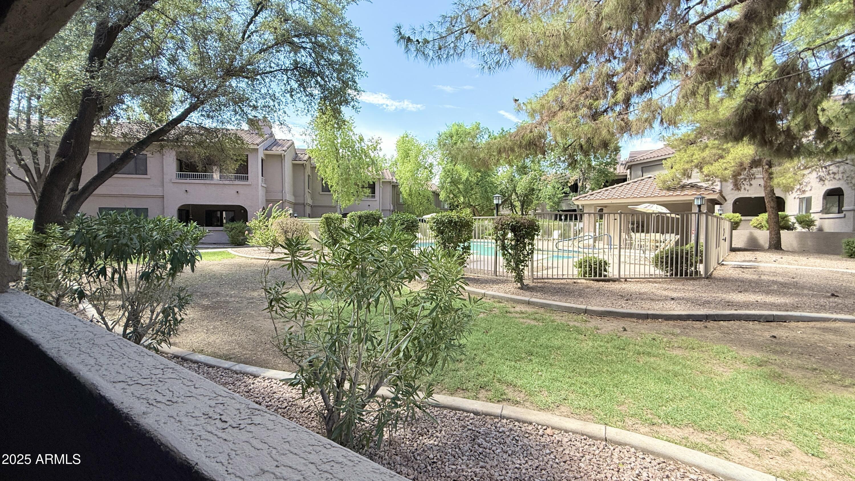 15050 North Thompson Peak Parkway, Unit 1012 Scottsdale, AZ 85260 - Photo 40 of 49 a front view of a house with a yard