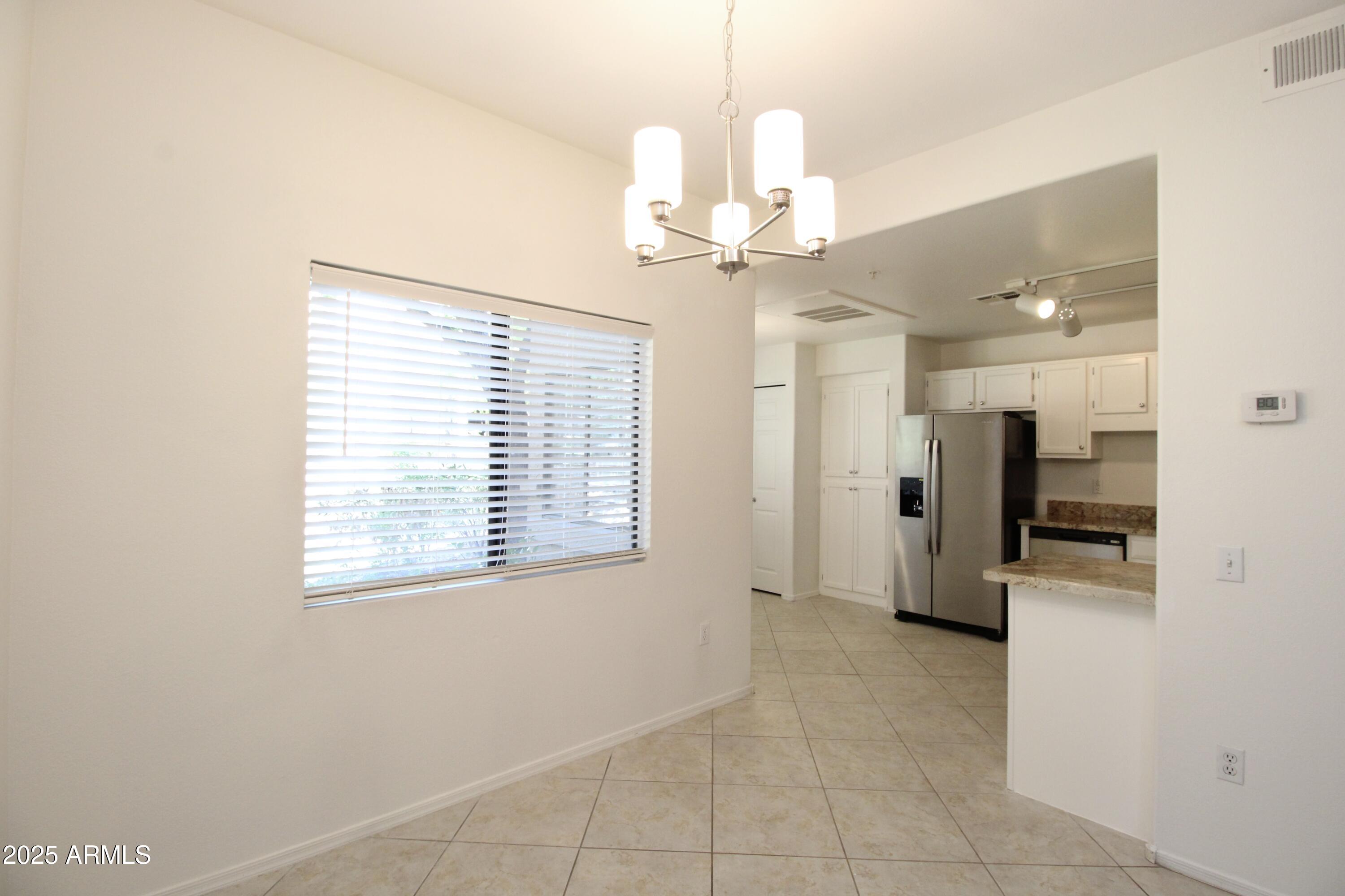 15050 North Thompson Peak Parkway, Unit 1012 Scottsdale, AZ 85260 - Photo 4 of 49 a view of a livingroom with a chandelier