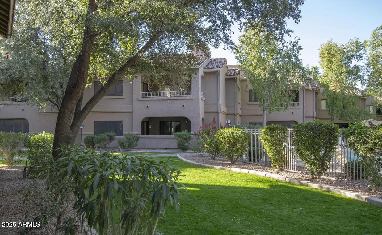 15050 North Thompson Peak Parkway, Unit 1012 Scottsdale, AZ 85260 - Photo 41 of 49 a view of a house with a garden and trees