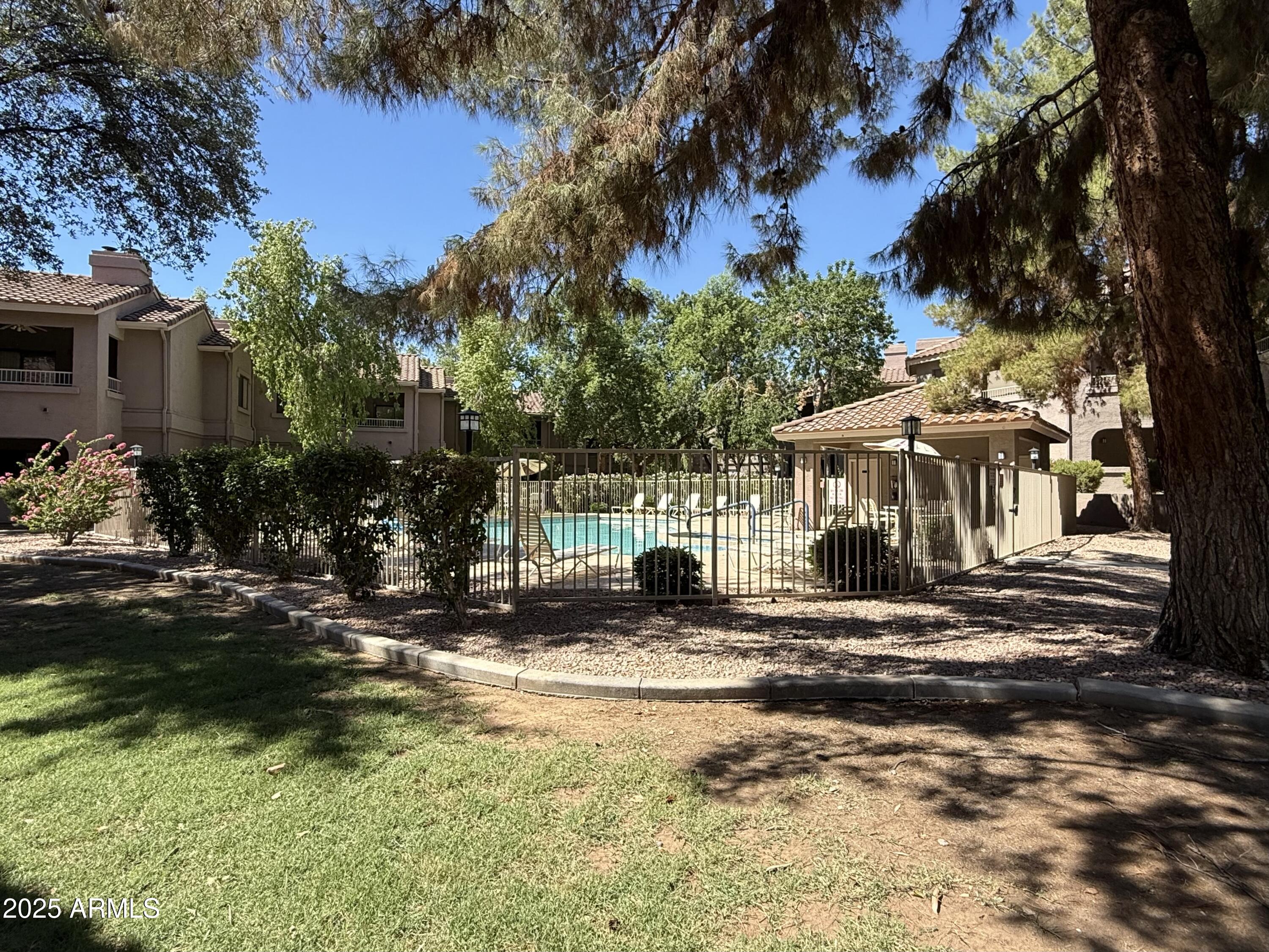 15050 North Thompson Peak Parkway, Unit 1012 Scottsdale, AZ 85260 - Photo 43 of 49 a front view of a house with a yard
