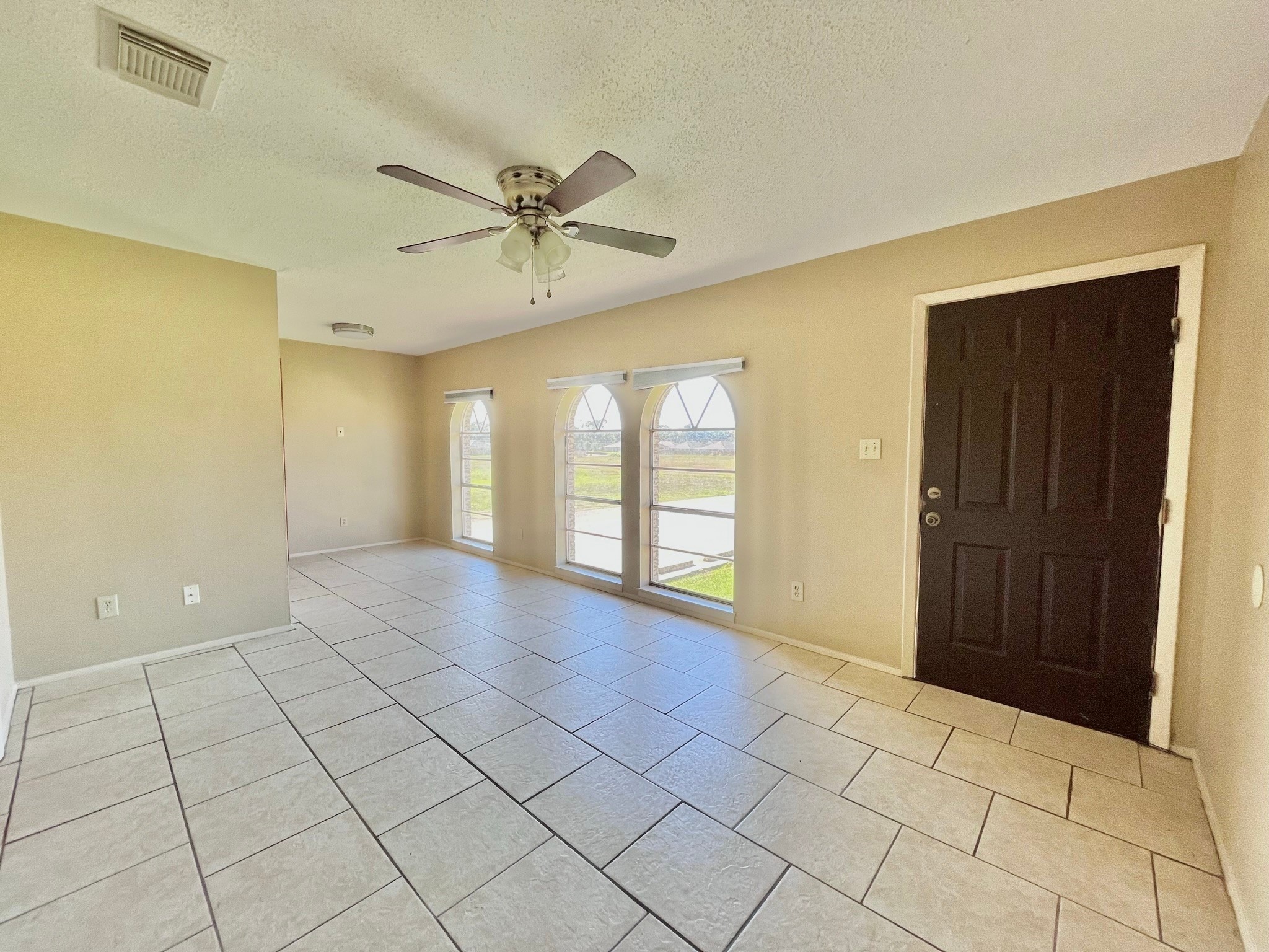 3021 Sycamore Avenue, Unit 10 Bay City, TX 77414 - Photo 2 of 12 a view of an empty room with window and chandelier fan