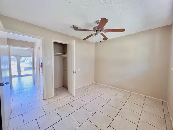 a view of a livingroom with wooden floor and a floor to ceiling window