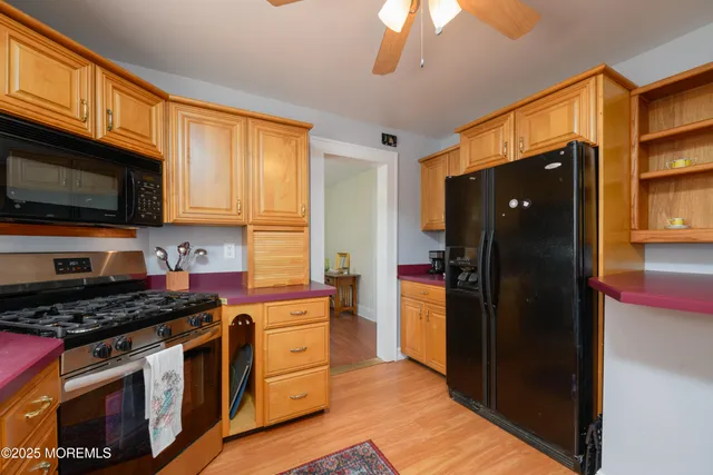 a kitchen with stainless steel appliances granite countertop a refrigerator stove and microwave