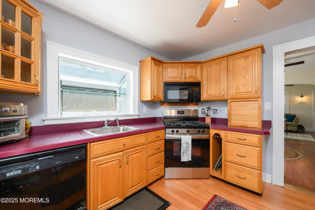 a kitchen with stainless steel appliances granite countertop a stove and a microwave