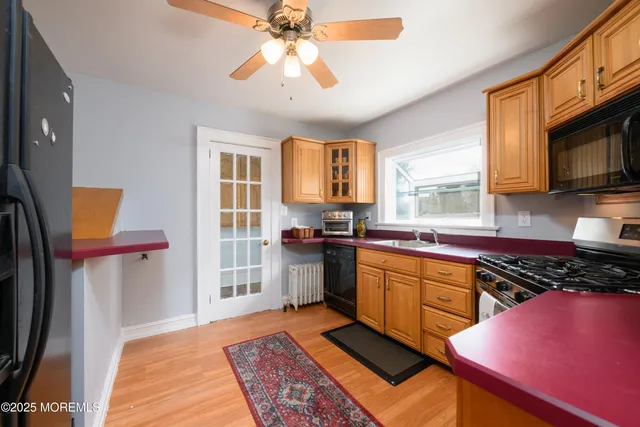 a kitchen with stainless steel appliances a stove a sink and a microwave