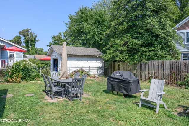 a view of a chairs and table in backyard of the house