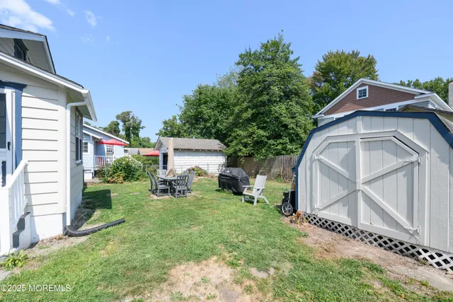 a view of a house with a yard and sitting area
