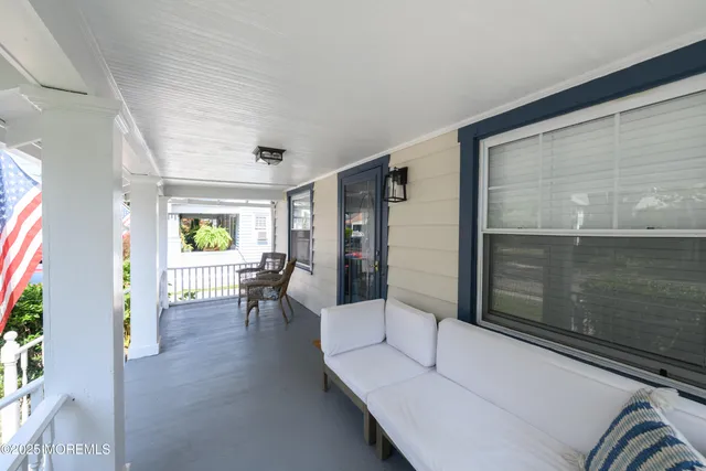 a living room with furniture and next to a window