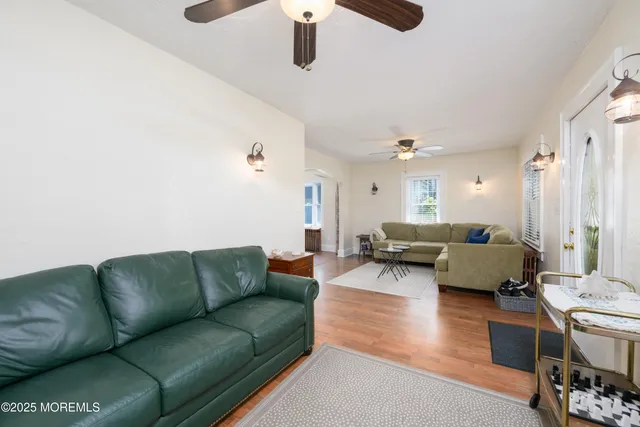 a living room with furniture and a chandelier