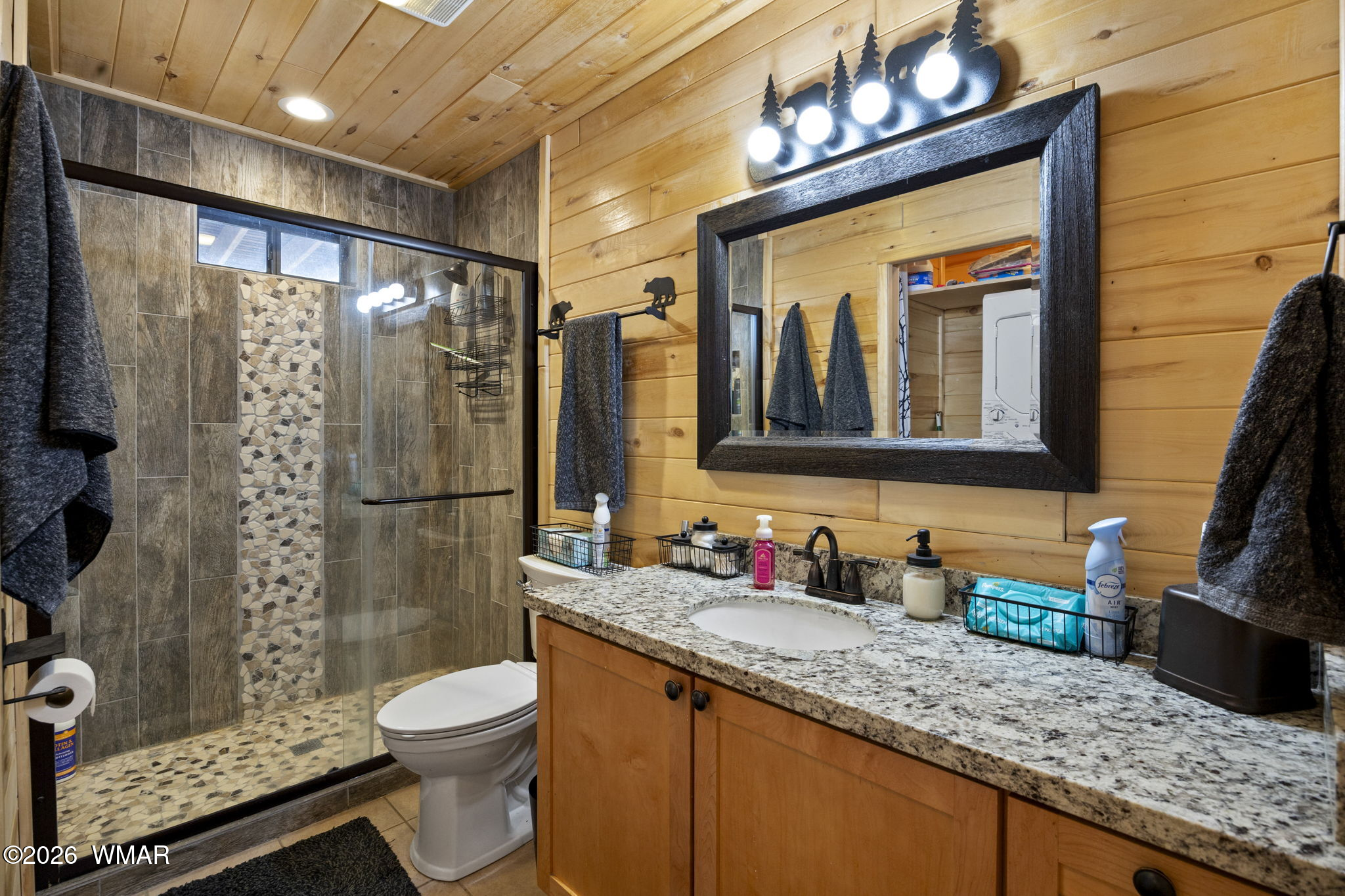 2741 Elk Trail Road Overgaard, AZ 85933 - Photo 47 of 68 a bathroom with a granite countertop sink toilet and shower