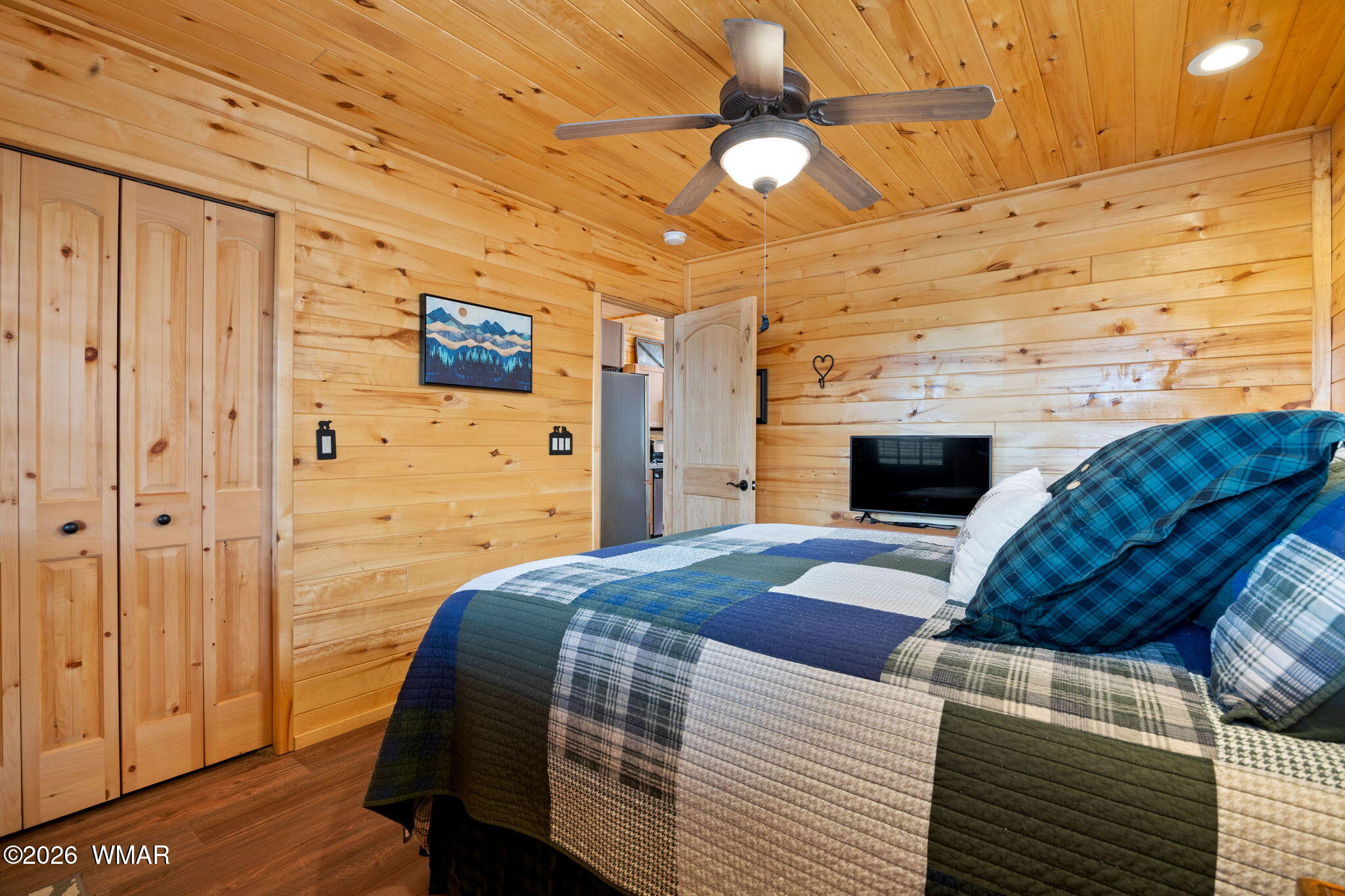 2741 Elk Trail Road Overgaard, AZ 85933 - Photo 14 of 68 a bedroom with a bed and a flat screen tv