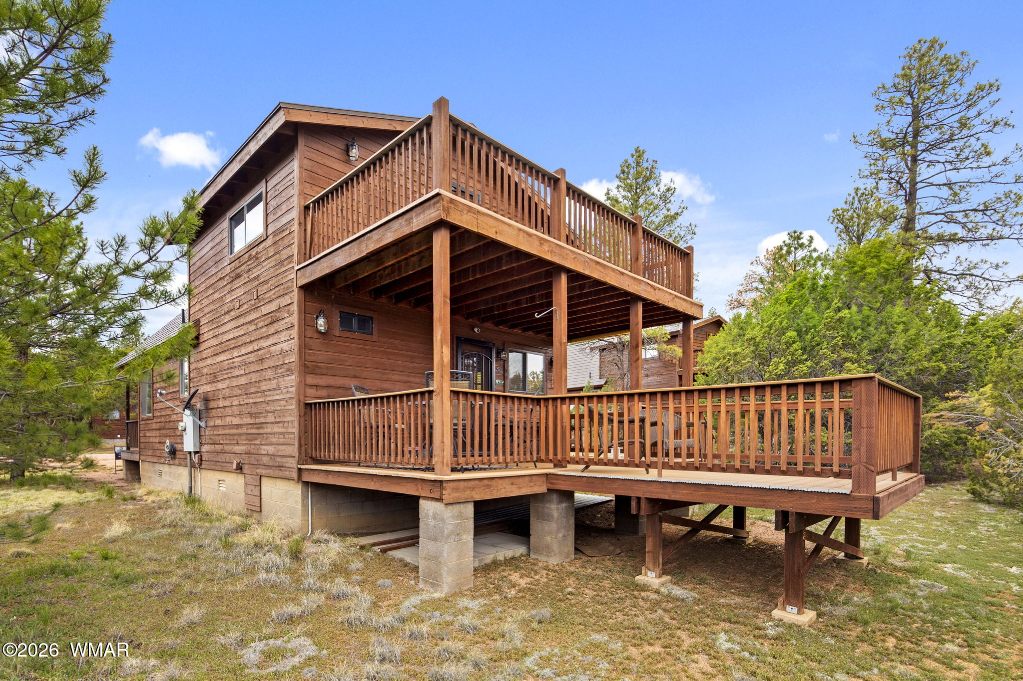 2741 Elk Trail Road Overgaard, AZ 85933 - Photo 56 of 68 a view of a roof deck with two chairs and a yard