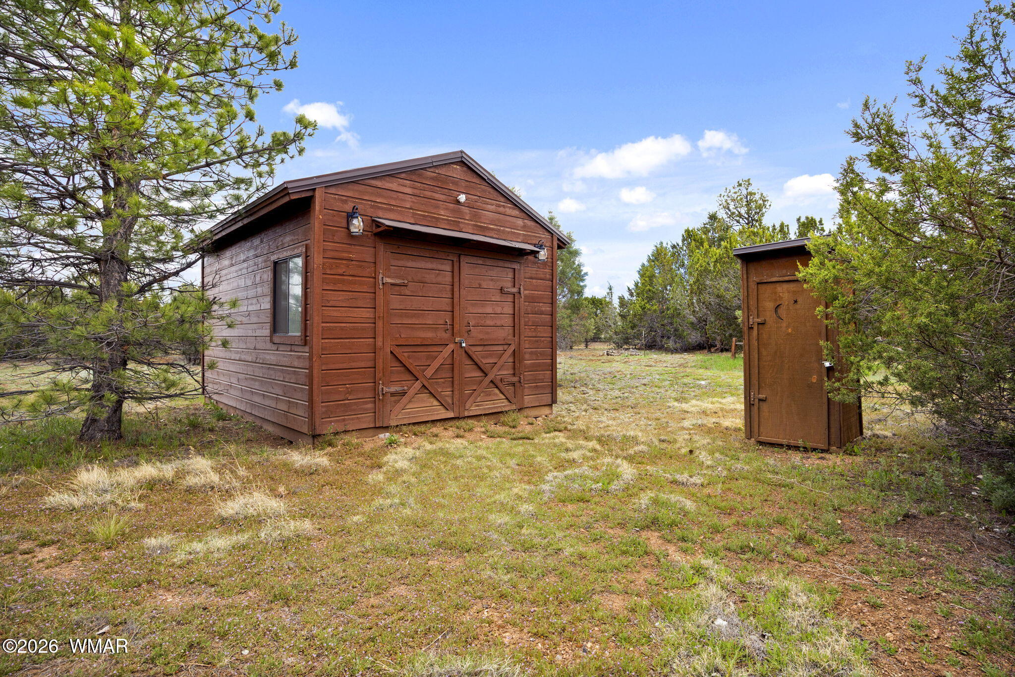 2741 Elk Trail Road Overgaard, AZ 85933 - Photo 26 of 68 a view of backyard with wooden fence and large trees